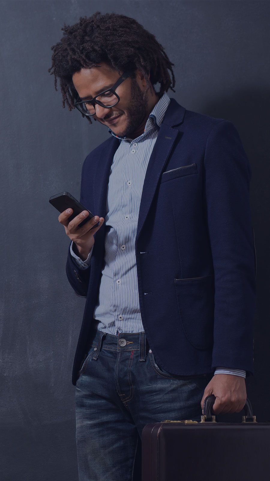 Man Holding a Briefcase and Smartphone
